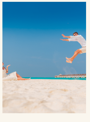 Anthony and Raisa jumping on the beach